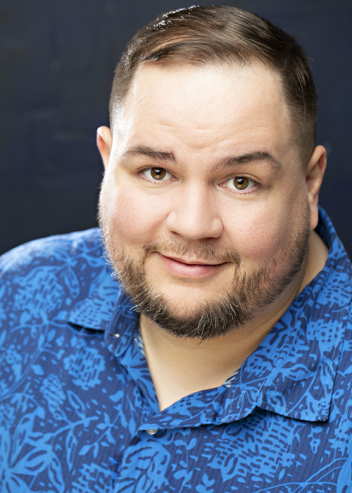 Soft smile, blue patterned shirt